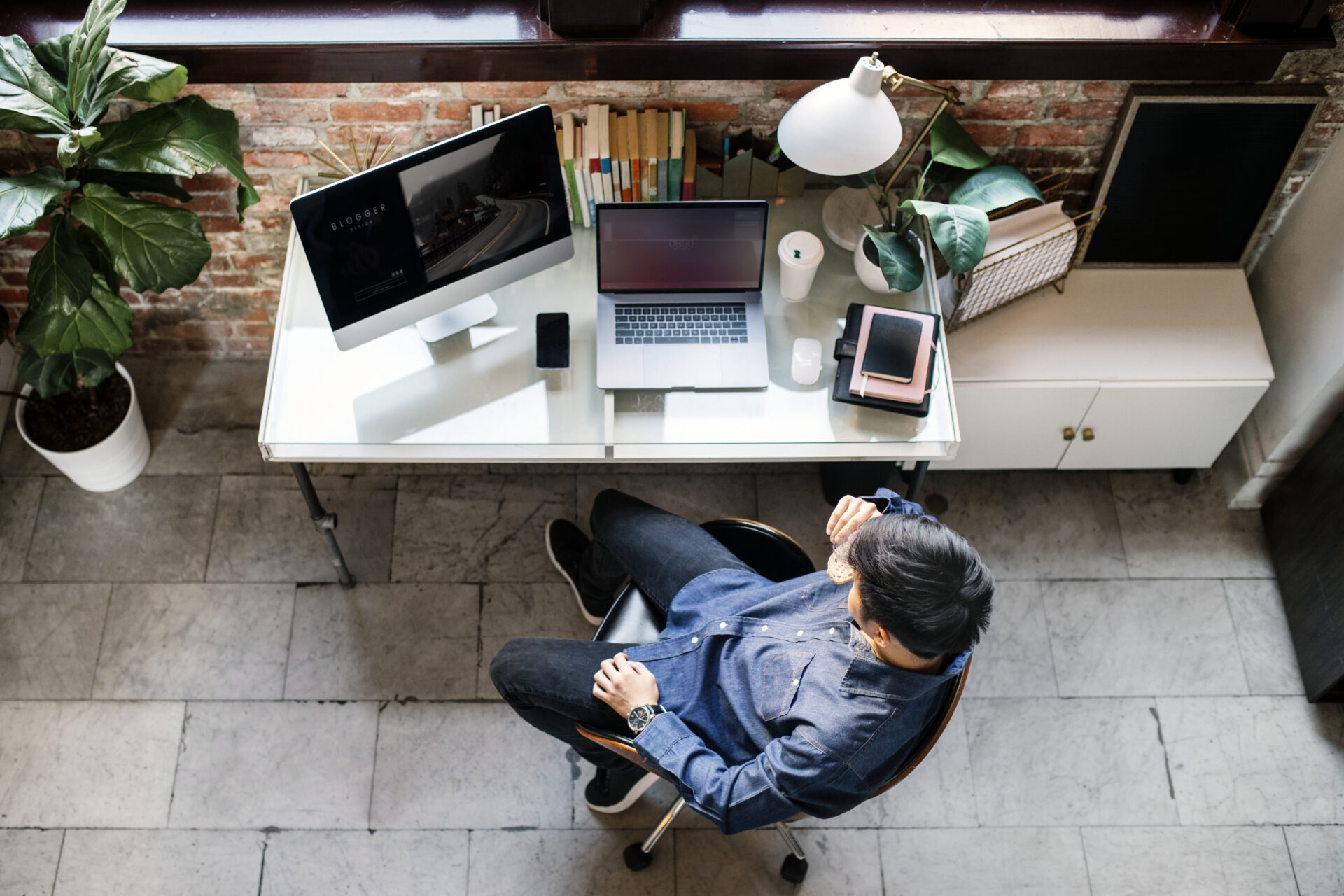 Blogger using a computer in his bedroom